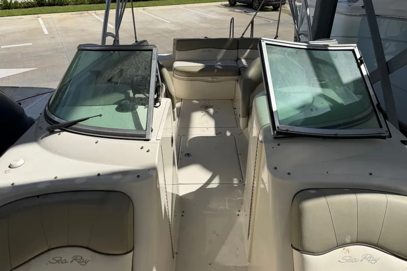 Slide: The Image of 2006 Sea Ray 240 Sundeck boat interior with open windshield and seating area. - 13