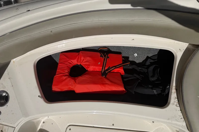 Slide: The Image of Storage compartment with life jacket on 2006 Sea Ray 240 Sundeck boat. - 50