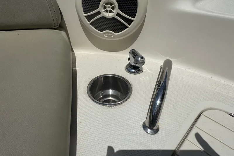 Slide: The Image of Interior of 2006 Sea Ray 240 Sundeck with speaker, cup holder, and chrome handle. - 5