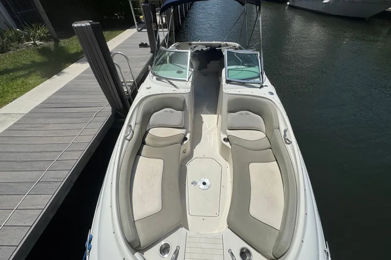 Slide: The Image of 2006 Sea Ray 240 Sundeck boat docked, featuring spacious seating and sleek design. - 1