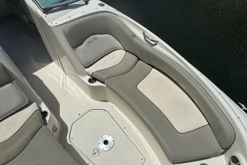 Slide: The Image of 2006 Sea Ray 240 Sundeck boat interior with cushioned seating and sleek design. - 8