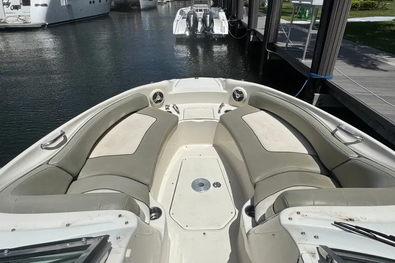 Slide: The Image of 2006 Sea Ray 240 Sundeck boat interior with spacious seating at dock. - 6
