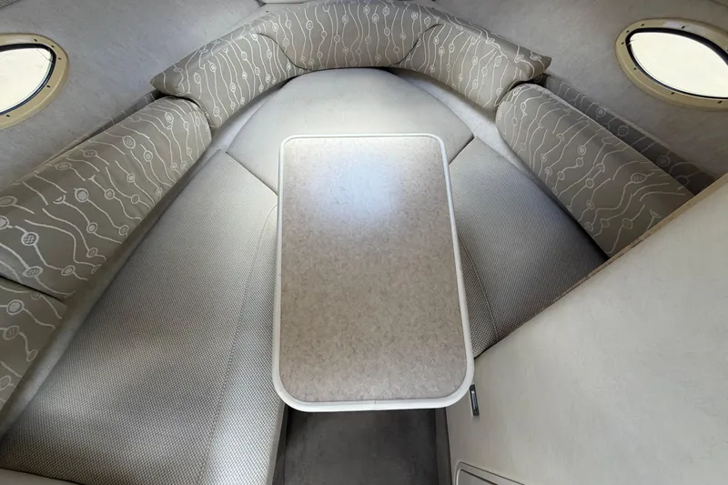 Slide: The Image of Interior cabin of 2006 Sea Ray 250 Amberjack with cushioned seating and table. - 40
