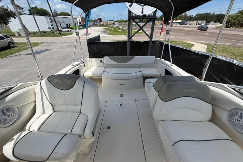 Slide: The Image of 2006 Sea Ray 250 Amberjack boat interior with white seating and canopy. - 56