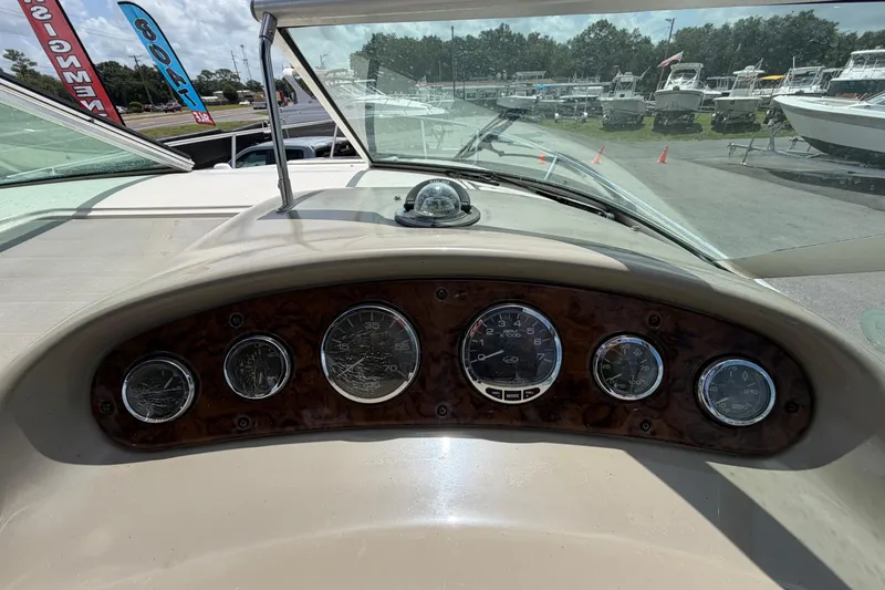Slide: The Image of Dashboard of a 2006 Sea Ray 250 Amberjack boat with gauges and compass. - 26