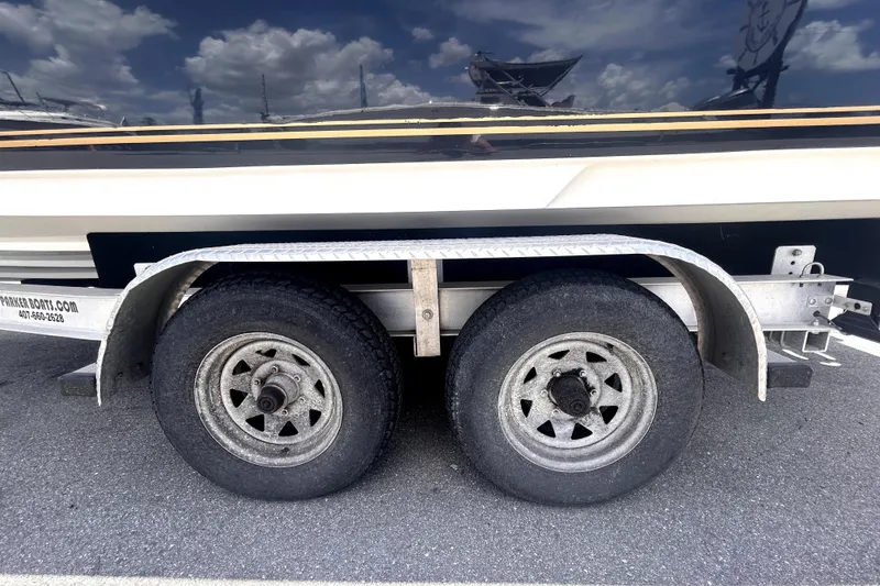 Slide: The Image of Trailer wheels of a 2006 Sea Ray 250 Amberjack boat on asphalt. - 65