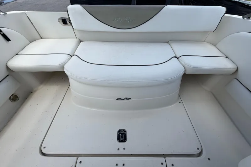 Slide: The Image of 2006 Sea Ray 250 Amberjack boat interior with white cushioned seating. - 58