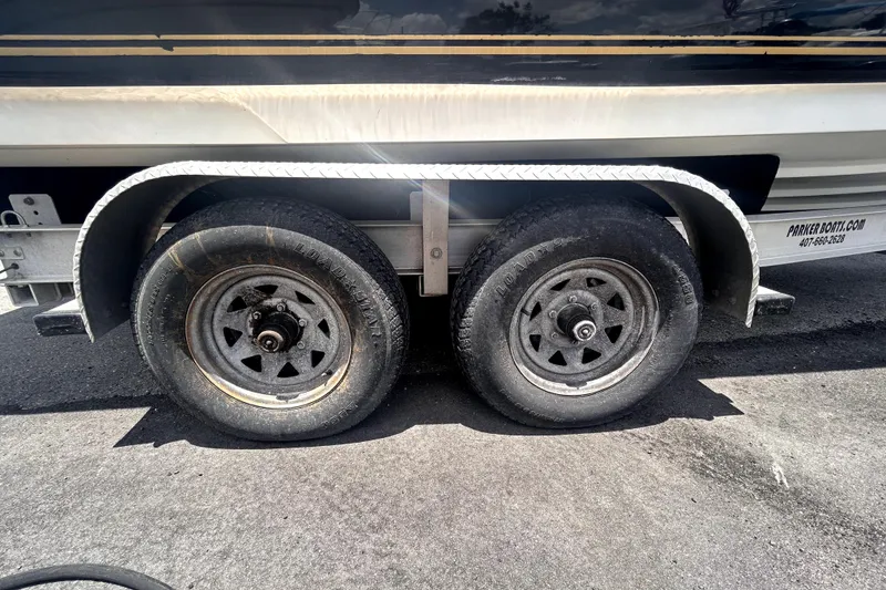 Slide: The Image of Trailer wheels of a 2006 Sea Ray 250 Amberjack boat on asphalt. - 66