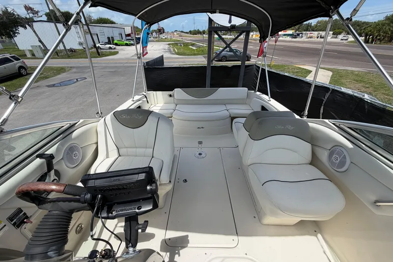 Slide: The Image of 2006 Sea Ray 250 Amberjack boat interior with seating and steering wheel. - 55