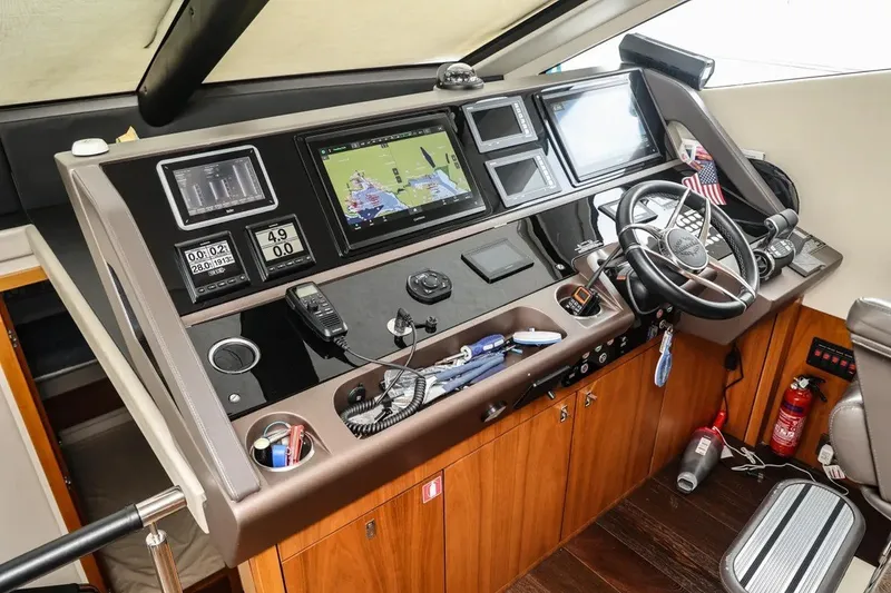 Slide: The Image of Cockpit of 2016 Sunseeker Manhattan 65 yacht with navigation equipment and steering wheel. - 15