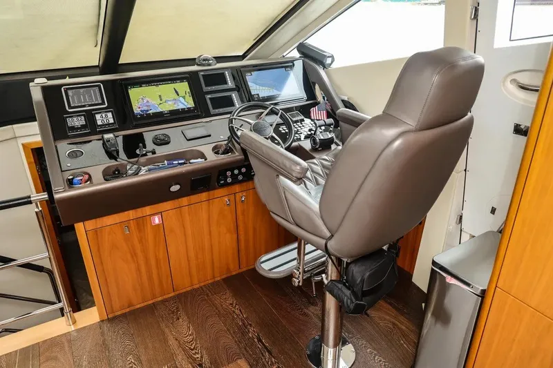 Slide: The Image of Helm station of 2016 Sunseeker Manhattan 65 yacht with navigation equipment and captain's chair. - 16