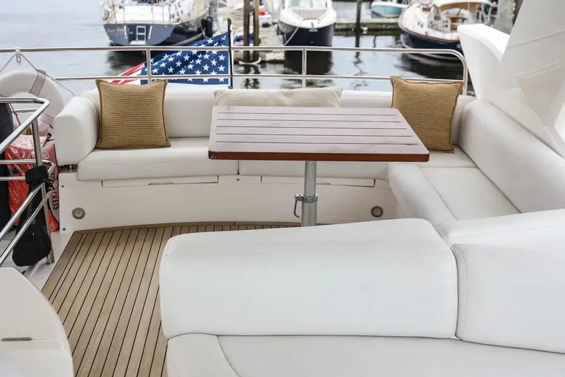 Slide: The Image of Luxurious seating area on a 2016 Sunseeker Manhattan 65 yacht with wooden table. - 19