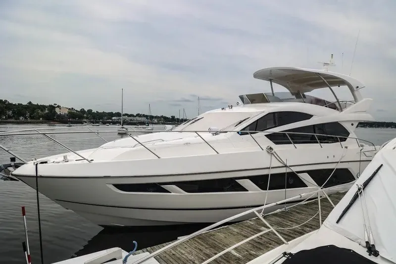 Slide: The Image of Luxury Sunseeker Manhattan 65 yacht docked, 2016 model, sleek design, waterfront view. - 28