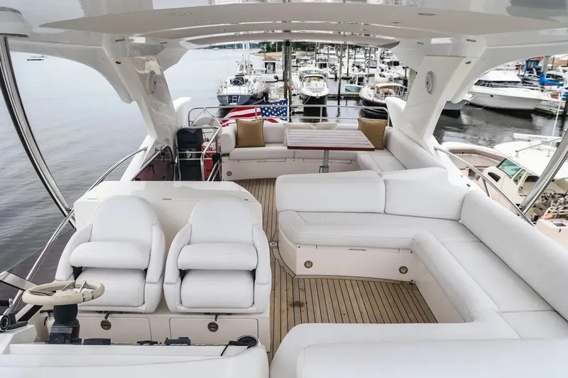Slide: The Image of Luxurious 2016 Sunseeker Manhattan 65 yacht interior with white seating and wooden flooring. - 21