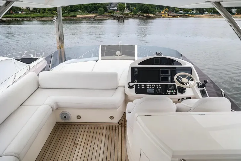 Slide: The Image of Luxurious 2016 Sunseeker Manhattan 65 yacht helm with plush seating and modern controls. - 22