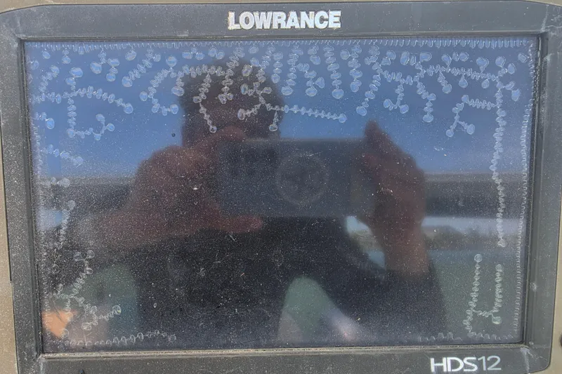 Slide: The Image of Lowrance HDS12 screen on 2014 Custom Exuma Catamaran 32, showing intricate patterns and reflections. - 21