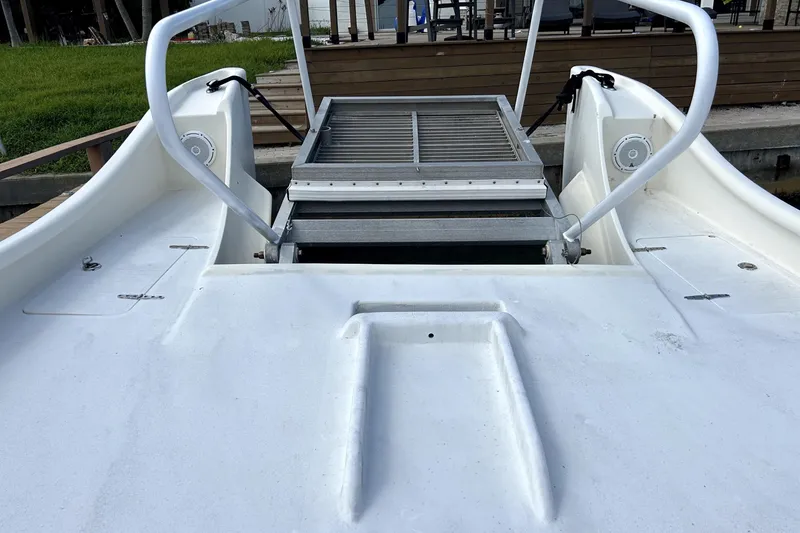 Slide: The Image of 2014 Custom Exuma Catamaran 32 with metal boarding ramp and white deck. - 26
