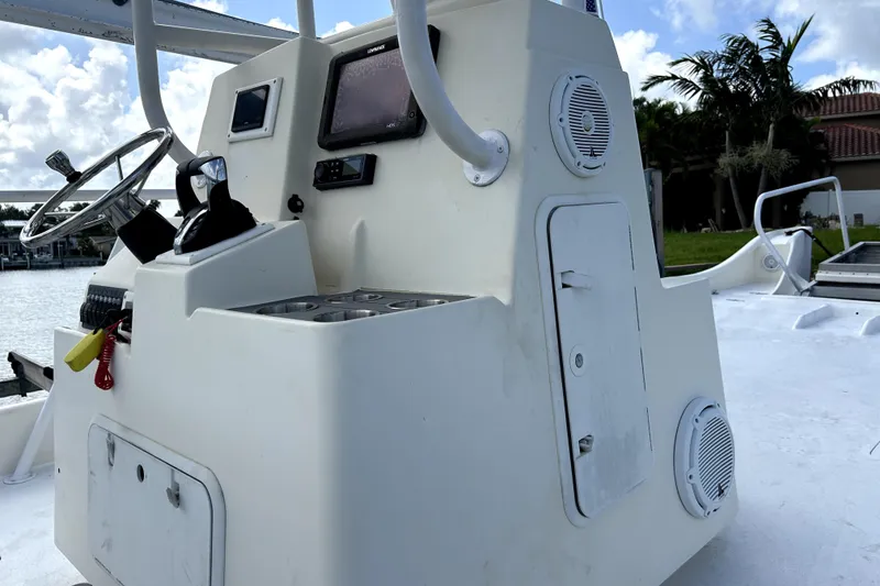 Slide: The Image of Control console of a 2014 Custom Exuma Catamaran 32, featuring steering wheel and navigation equipment. - 23