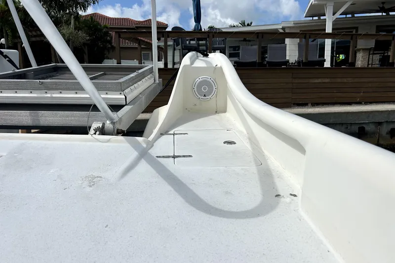 Slide: The Image of 2014 Custom Exuma Catamaran 32 deck with speaker, docked near waterfront homes. - 31