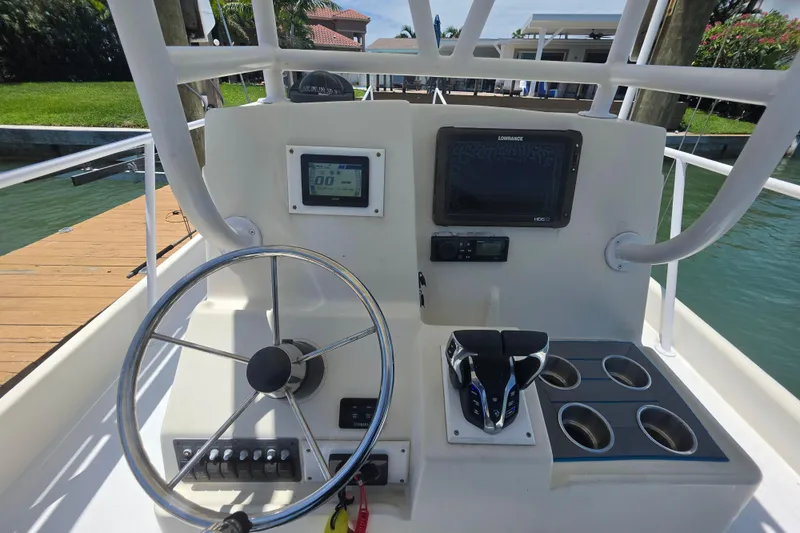 Slide: The Image of Cockpit of 2014 Custom Exuma Catamaran 32 with steering wheel and navigation equipment. - 16