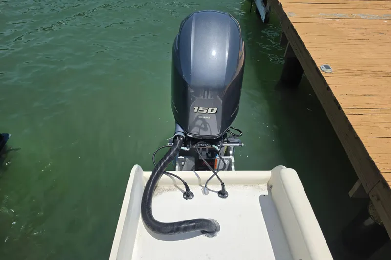 Slide: The Image of Outboard motor on 2014 Custom Exuma Catamaran 32 docked by wooden pier. - 40