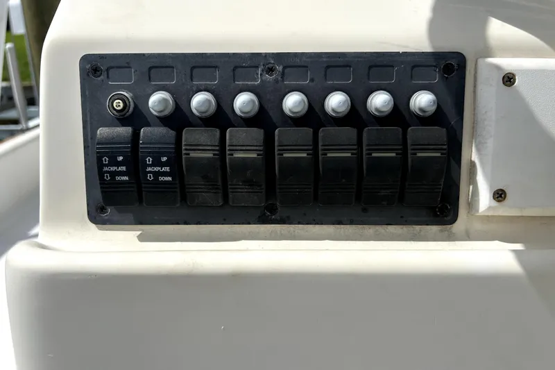 Slide: The Image of Control panel of a 2014 Custom Exuma Catamaran 32 with switches and jackplate controls. - 17
