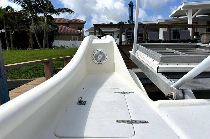 Slide: The Image of 2014 Custom Exuma Catamaran 32 docked near a modern waterfront home. - 29