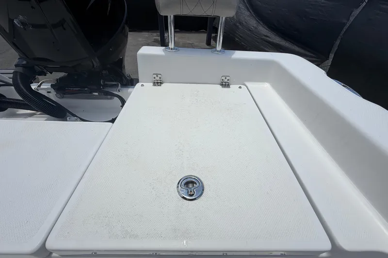 Slide: The Image of Rear deck of 2025 Savannah 210X boat with storage compartment and motor. - 55
