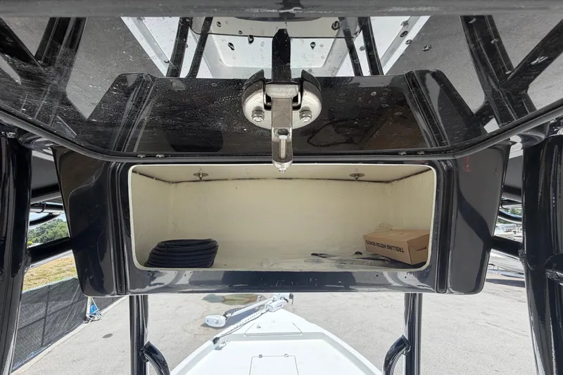 Slide: The Image of Storage compartment of 2025 Savannah 210X boat, featuring a secure latch and spacious interior. - 18