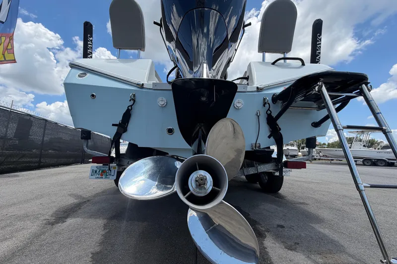 Slide: The Image of Rear view of 2025 Savannah 210X boat with propeller and ladder, parked outdoors. - 5