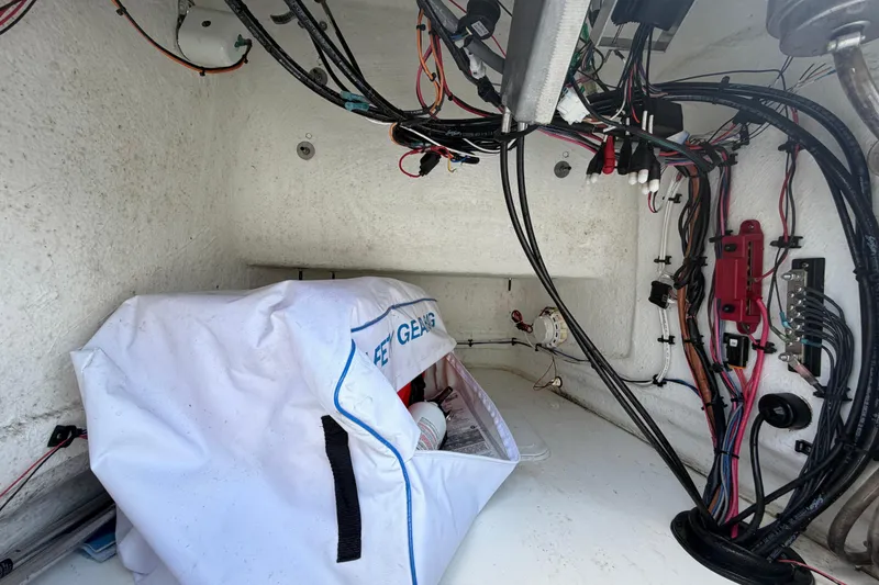 Slide: The Image of Interior view of a 2025 Savannah 210X boat showing wiring and storage compartment. - 27