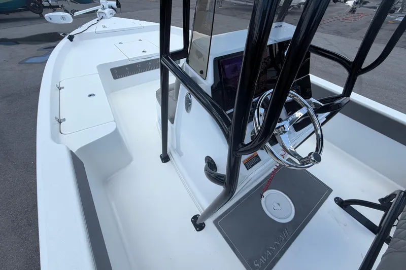 Slide: The Image of 2025 Savannah 210X boat interior with steering wheel and console, showcasing modern design. - 28