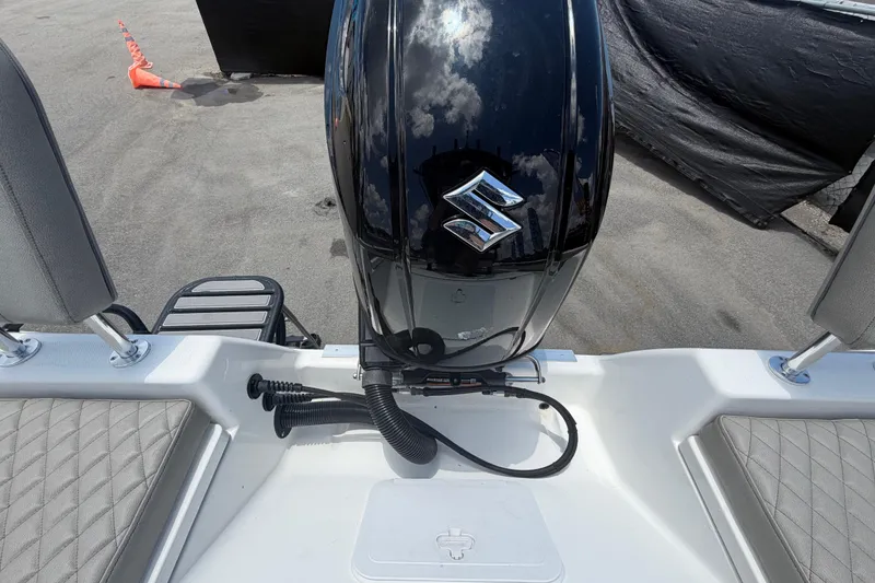 Slide: The Image of 2025 Savannah 210X boat with Suzuki outboard motor, rear view on dock. - 58