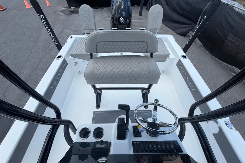 Slide: The Image of 2025 Savannah 210X boat interior with steering wheel and seating, showcasing modern design. - 46