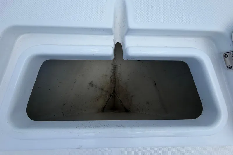 Slide: The Image of An open storage compartment on a 2025 Savannah 210X boat. - 38