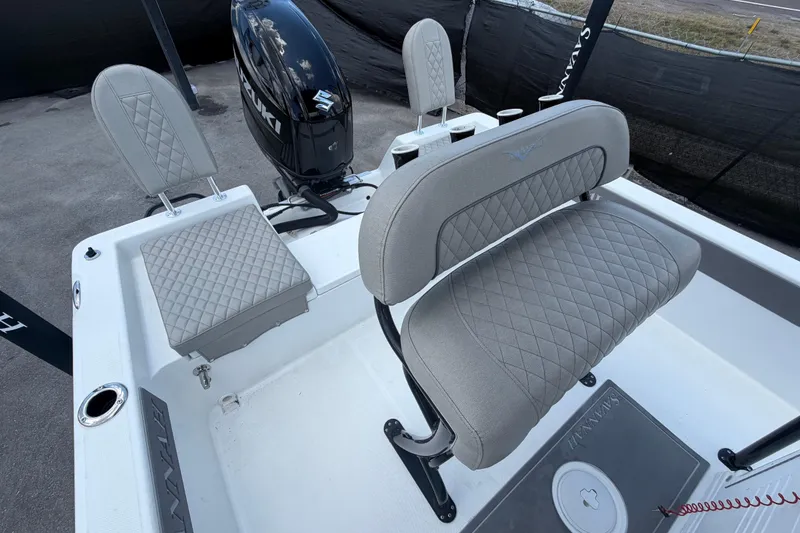 Slide: The Image of 2025 Savannah 210X boat interior with quilted seats and Suzuki outboard motor. - 48