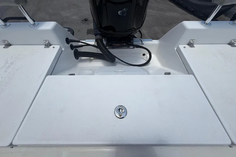 Slide: The Image of 2025 Savannah 210X boat deck with storage compartments and engine view. - 53