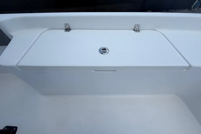 Slide: The Image of White storage compartment on a 2025 Savannah 210X boat deck. - 30