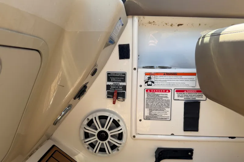 Slide: The Image of Control panel of a 2006 Sea Ray 300 Sundancer boat with warning labels and speaker. - 39