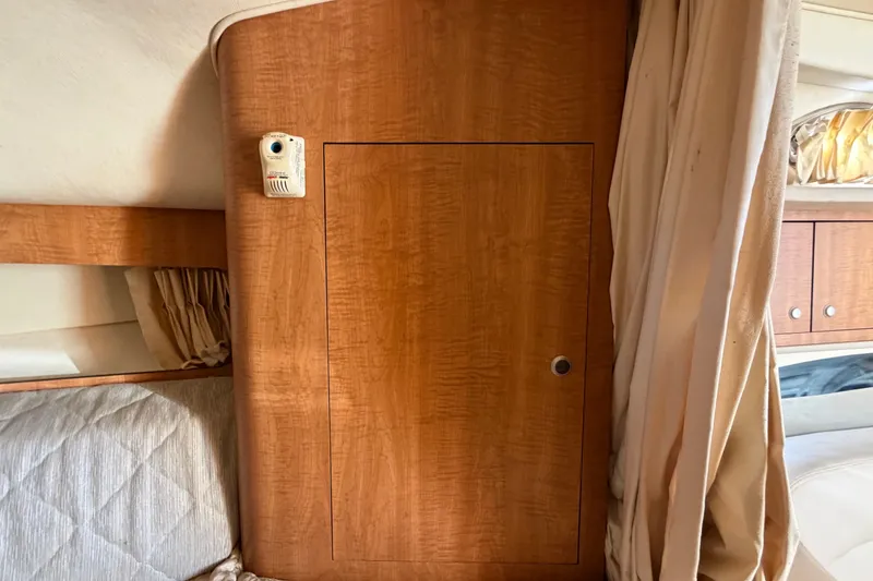 Slide: The Image of Interior cabin of 2006 Sea Ray 300 Sundancer with wood paneling and curtain. - 80