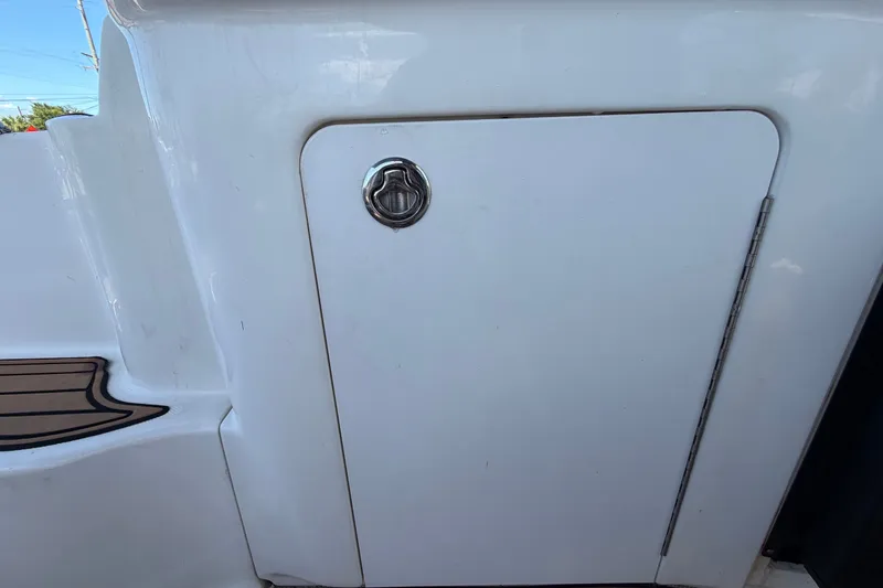 Slide: The Image of Hatch door on a 2006 Sea Ray 300 Sundancer boat, featuring a sleek white finish. - 24