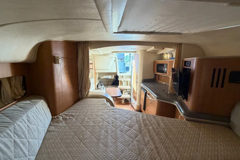 Slide: The Image of Interior of 2006 Sea Ray 300 Sundancer yacht with cozy cabin and kitchenette. - 83