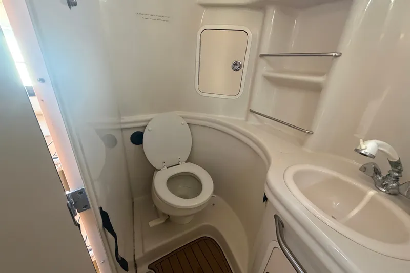Slide: The Image of Bathroom interior of 2006 Sea Ray 300 Sundancer boat with toilet and sink. - 20