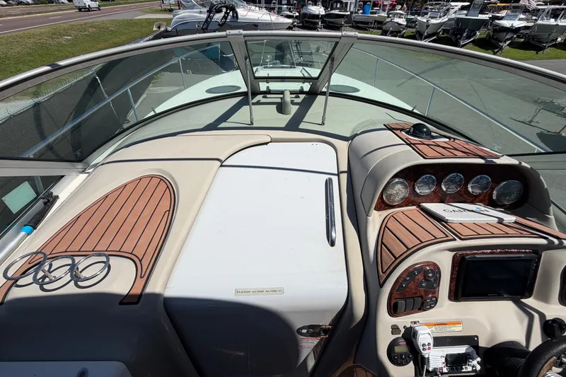 Slide: The Image of 2006 Sea Ray 300 Sundancer cockpit with wood accents and navigation instruments. - 43
