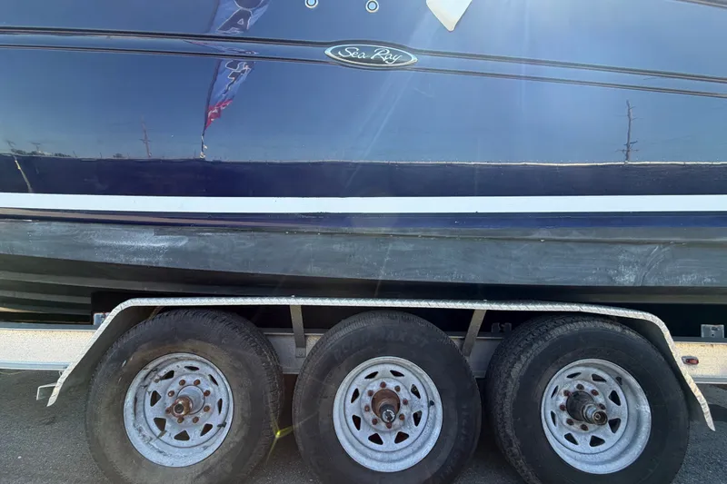 Slide: The Image of 2006 Sea Ray 300 Sundancer boat on trailer, side view with visible wheels. - 117