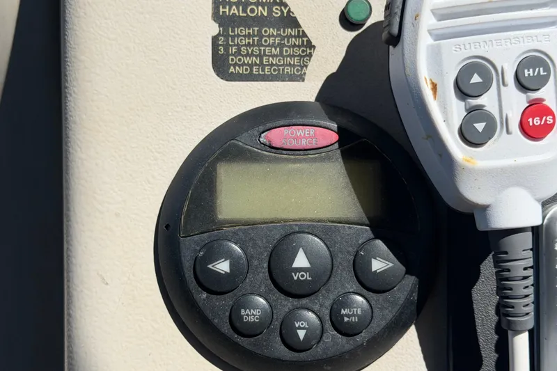Slide: The Image of Control panel on a 2006 Sea Ray 300 Sundancer boat, featuring audio and communication controls. - 32