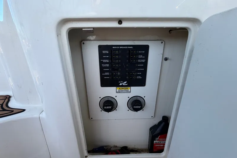 Slide: The Image of Main breaker panel on 2006 Sea Ray 300 Sundancer boat, with controls and oil container. - 25