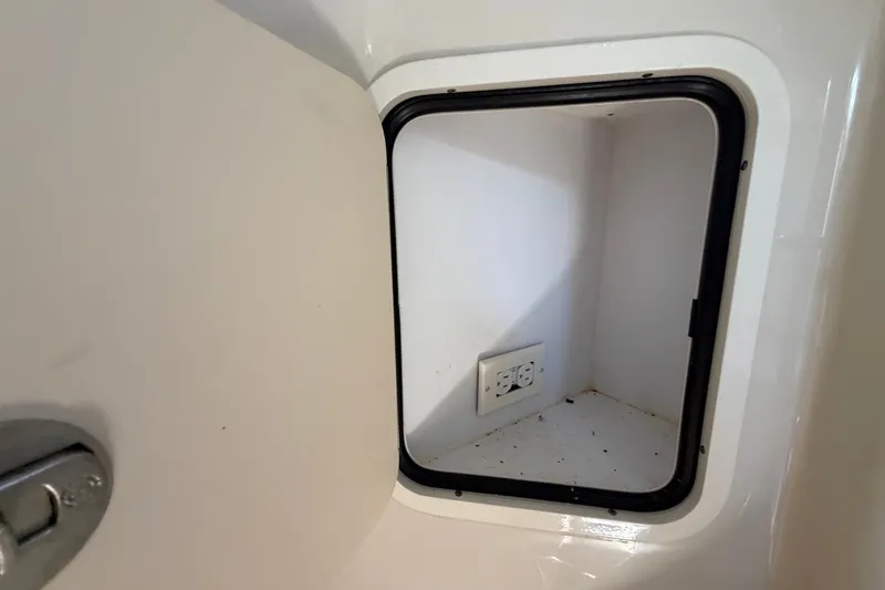 Slide: The Image of Storage compartment with electrical outlet on 2006 Sea Ray 300 Sundancer boat. - 62