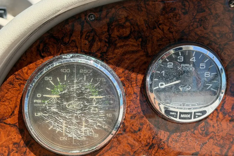 Slide: The Image of Cracked gauges on a 2006 Sea Ray 300 Sundancer boat dashboard. - 35