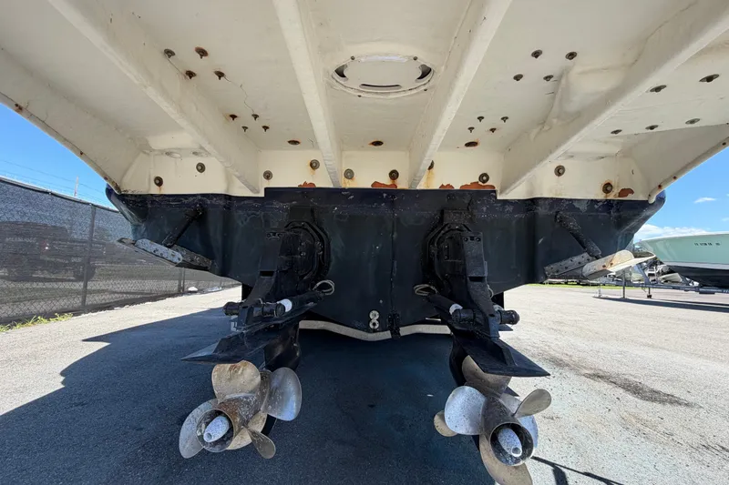 Slide: The Image of 2006 Sea Ray 300 Sundancer boat hull and propellers in a marina setting. - 4